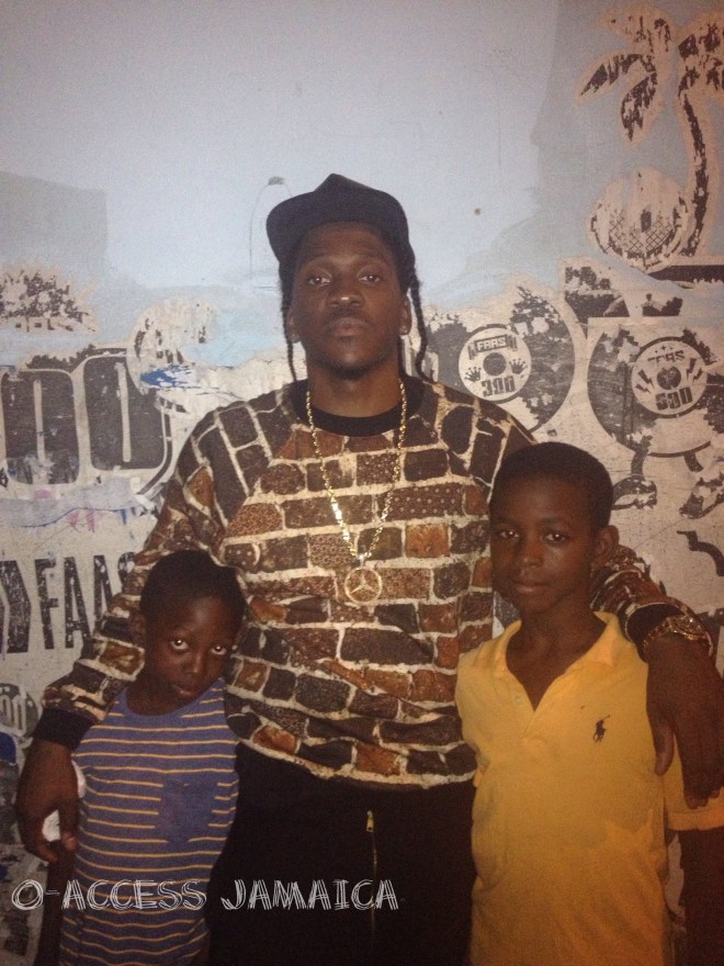 Pusha T hangs out with some kids in downtown Kingston.